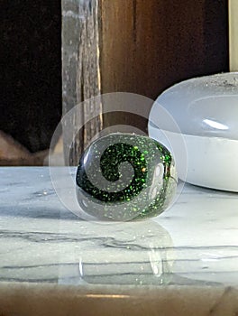 Green Goldstone on Marble Plate