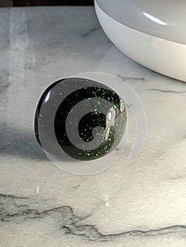 Green Goldstone on Marble Plate