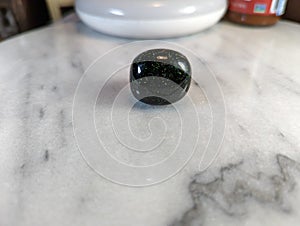 Green Goldstone on Marble Plate