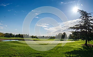 Green golf course against blue sky