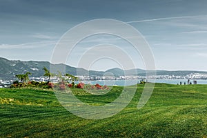 Green Golf Course With Mountains And Sea