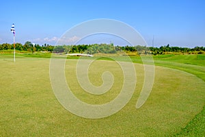 Green golf field and blue cloud sky for backdrop background use