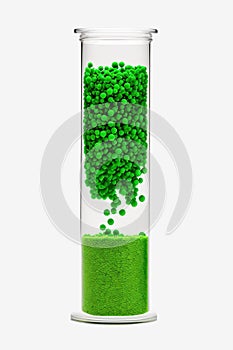 Green granules of biodegradable plastic in lab tube