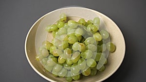 Green grape in the ceramic plate.