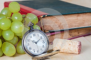 Green grape and old pocket clock