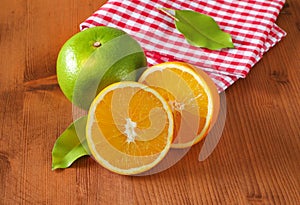 Green grapefruit and halved orange