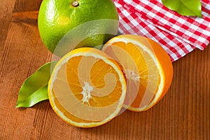 Green grapefruit and halved orange