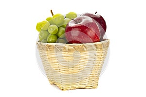 Green grapes and red in a weave bamboo basket