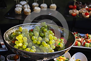 Green grapes in a silver bowl at a buffet table
