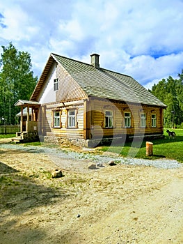 Green grass, blue sky, thatched house