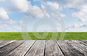 Green grass, blue sky and white clouds with wooden floor backgrounds