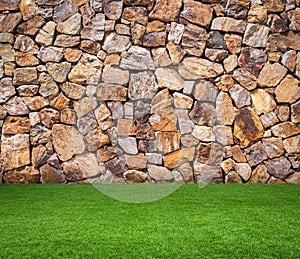 Green grass with brown stone background
