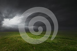 Green grass and a dramatic dark sky