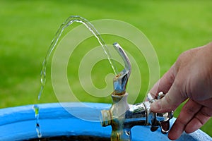 Drinking Fountain with Water Flowing to Drink Hand Turning Valve Wet