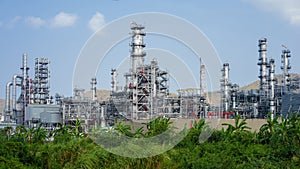 green grass field and Oil refinery factory plant or petrochamical and power