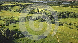 Green grass fields and forests at river shore aerial. Nobody nature landscape. Greenery valley