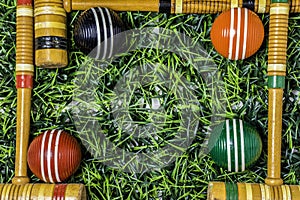 Frame of Croquet Mallets and Balls on Grass photo