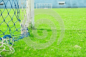 Green grass and goal at the stadium. stadium is place for soccer or football match. people come for cheer their favorite team to