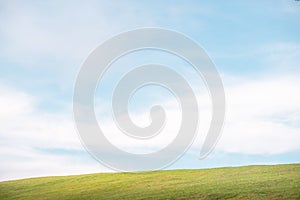 Green grass on the hills with clear blue sky