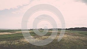 Green grass meadows and fields landscape in a sunny day - vintage effect