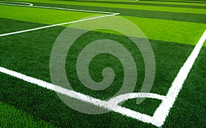 Green grass soccer field. Empty artificial turf football field with white line. View from the corner of soccer field. Sport