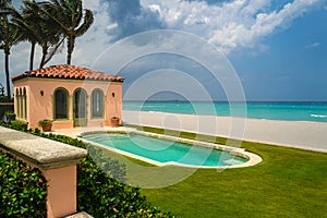 Green grass terrace near swimming pool and garden in modern beach house or luxury villa.