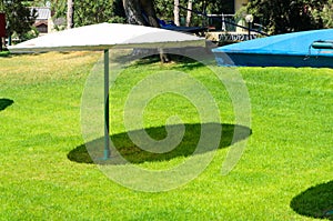 Green grass and two-umbrella canopy from the sun