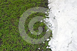 Green grass and white snow