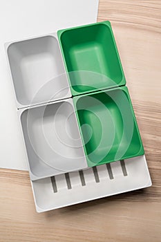 Green and grey plastic trays arrangement.