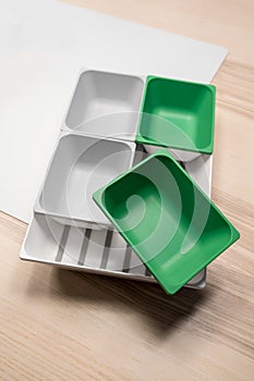 Green and grey plastic trays arrangement.