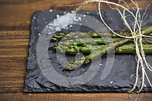 Green or grilled asparagus on a slate with coarse salt