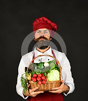 Green grocery concept. Man with beard holds veggies