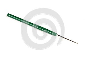 Green handle on metallic crochet hook for knitting isolated on white background