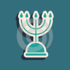 Green Hanukkah menorah icon isolated on green background. Hanukkah traditional symbol. Holiday religion, jewish festival
