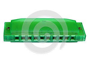 Green harmonica, isolated on white background