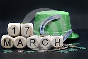 Green hat, green necklaces and clovers, horseshoes, lucky coins and dice with letters March 17