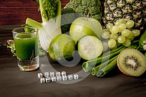 Green health smoothie fruits and vegetables, kale leaves, lime, apple, kiwi, grapes, banana, avocado, lettuce pineapple