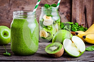 Green healthy smoothie in glass jar: banana, kiwi, spinach, green apple