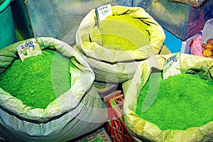 Green henna powder in bags, on souk market in Muscat