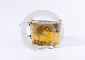 Green herbal tea in a transparent cup isolated on white