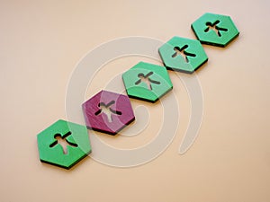 Green hexagons with figures and red one. Impostor syndrome concept.