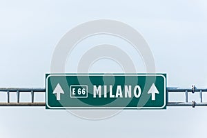 Green highway road sign to Milano