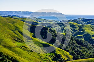 Green Hills, Blue Ocean, and Sky