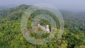 Green hills of Magelang with quirk Chicken Church, Java Indonesia, aerial panorama