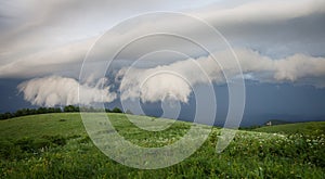 Green hills under cloudy sky