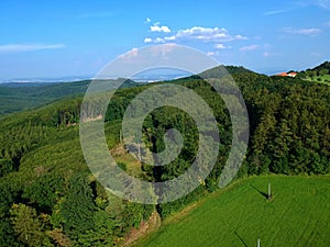 Green hills, woods and meadow near castle Buchlov from drone