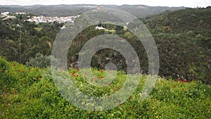 Green hilly landscape with hilltop medieval castle, near Belver, Portugal