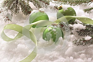 Green holiday balls in snow