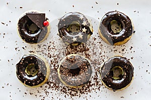 Green homemade donuts from matcha tea with chocolate icing and decoration from stars and chocolate on a white background.