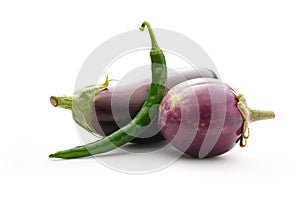 Green hot chilly pepper with two eggplants